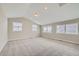 Spacious carpeted bedroom with vaulted ceilings and several bright, sunny windows at 6906 Kendrick Ln, Arvada, CO 80007