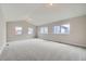 Large bedroom featuring vaulted ceilings, neutral paint, and multiple windows for plenty of light at 6906 Kendrick Ln, Arvada, CO 80007
