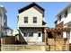 Stylish two-story home with a brick facade, pergola, and a well-maintained fence at 6906 Kendrick Ln, Arvada, CO 80007