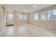 Spacious living area with light wood flooring, large windows, and ample natural light at 6906 Kendrick Ln, Arvada, CO 80007