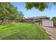 Expansive backyard with lush lawn, deck, and shed, perfect for outdoor activities at 2176 S Welch Cir, Lakewood, CO 80228