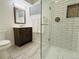 Updated bathroom featuring a glass shower, modern vanity, and stylish tile work at 2176 S Welch Cir, Lakewood, CO 80228