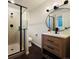 Bathroom featuring a glass shower stall and modern vanity with dark hardware at 2176 S Welch Cir, Lakewood, CO 80228