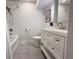 Bathroom featuring a shower-tub combo, gray tile and a white vanity at 2176 S Welch Cir, Lakewood, CO 80228