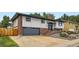 Front view of a property with a large concrete driveway and rock and shrub landscaping at 2176 S Welch Cir, Lakewood, CO 80228