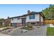 Beautiful house showcasing stone landscaping, gray trim, brick accents, and mature yard at 2176 S Welch Cir, Lakewood, CO 80228