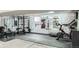 Spacious gym with painted brick and a large variety of workout equipment at 2176 S Welch Cir, Lakewood, CO 80228