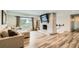Bright living room features wood floors, brick fireplace, and a large window at 2176 S Welch Cir, Lakewood, CO 80228