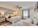 Relaxing primary bedroom featuring a king bed, sitting area, and plenty of natural light at 2176 S Welch Cir, Lakewood, CO 80228
