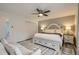 Spacious primary bedroom featuring a king bed, accent wall, ceiling fan and neutral decor at 2176 S Welch Cir, Lakewood, CO 80228