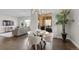 Open dining area with hardwood floors, modern lighting, and sliding doors to the patio at 671 Hiddenbrook Ct, Littleton, CO 80126