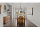 Formal dining room with hardwood floors, decorative lighting, and large windows at 671 Hiddenbrook Ct, Littleton, CO 80126