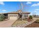 Beautiful stone home featuring an attached garage, lovely landscaping, and neutral color palette at 671 Hiddenbrook Ct, Littleton, CO 80126