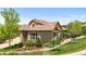 Attractive home with a stone and siding exterior, complemented by mature landscaping at 671 Hiddenbrook Ct, Littleton, CO 80126