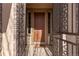 Inviting front door with decorative ironwork and sidelights, creating a warm welcome at 671 Hiddenbrook Ct, Littleton, CO 80126