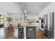 Bright kitchen featuring stainless appliances, an island with seating, and adjacent breakfast nook at 671 Hiddenbrook Ct, Littleton, CO 80126
