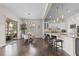 Open-concept kitchen featuring a breakfast bar, pendant lighting, and access to the outdoor patio at 671 Hiddenbrook Ct, Littleton, CO 80126
