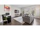 Spacious living room showcasing large windows, hardwood floors, a fireplace, and stylish decor at 671 Hiddenbrook Ct, Littleton, CO 80126