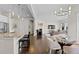 Bright living space featuring hardwood floors, an open layout, and convenient kitchen access at 671 Hiddenbrook Ct, Littleton, CO 80126