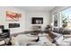 Inviting living room with hardwood floors, a fireplace, a TV, and comfortable seating at 671 Hiddenbrook Ct, Littleton, CO 80126