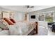 Cozy bedroom featuring a comfortable bed, window, and view into the bathroom at 2757 E Geddes Ave, Centennial, CO 80122