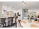 Bright kitchen dining area is open to island kitchen with granite counters and pendant lighting at 2757 E Geddes Ave, Centennial, CO 80122