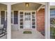 Inviting front porch featuring a welcome mat, sidelight windows, and neutral tones at 2757 E Geddes Ave, Centennial, CO 80122