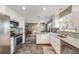 Bright kitchen features stainless steel appliances, granite countertops, and breakfast nook at 2757 E Geddes Ave, Centennial, CO 80122