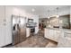 Open-concept kitchen with stainless steel appliances, granite countertops, and tile floors at 2757 E Geddes Ave, Centennial, CO 80122