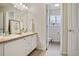 Bathroom featuring double sinks and doorway to toilet area at 17032 Blue Mist Grv, Monument, CO 80132