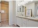 Bright bathroom featuring double sinks, vanity and walk in closet at 17032 Blue Mist Grv, Monument, CO 80132