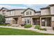 Charming townhouse exterior with stone accents and well-maintained landscaping on a sunny day at 17032 Blue Mist Grv, Monument, CO 80132