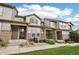 Charming townhome featuring stone accents and a well-manicured lawn, creating a welcoming curb appeal at 17032 Blue Mist Grv, Monument, CO 80132