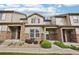 Charming townhome featuring stone accents and a well-manicured lawn, creating a welcoming curb appeal at 17032 Blue Mist Grv, Monument, CO 80132