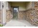 Close up of front door featuring stone accents and a welcome mat at 17032 Blue Mist Grv, Monument, CO 80132
