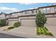 A row of garages showcasing ample parking and complemented by green landscaping at 17032 Blue Mist Grv, Monument, CO 80132