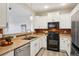 Well-lit kitchen featuring stainless steel appliances, ample counter space, and modern cabinetry at 17032 Blue Mist Grv, Monument, CO 80132