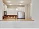 A view of the kitchen with stainless steel appliances, white cabinets, and tile backsplash at 17032 Blue Mist Grv, Monument, CO 80132