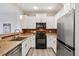 Modern kitchen with stainless steel appliances, sleek black hardware and ample counter space at 17032 Blue Mist Grv, Monument, CO 80132