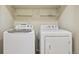 Laundry room featuring washer, dryer and wire shelving above at 17032 Blue Mist Grv, Monument, CO 80132