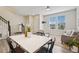Bright living room with a white table, stairs and windows at 17032 Blue Mist Grv, Monument, CO 80132
