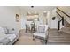 Cozy and bright living area with staircase and view to modern kitchen at 17032 Blue Mist Grv, Monument, CO 80132