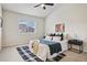 Bright main bedroom with a large window and fan at 17032 Blue Mist Grv, Monument, CO 80132