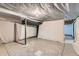 Unfinished basement with covered walls, ideal for storage at 303 Tumbleweed Dr, Brighton, CO 80601