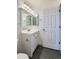 Clean bathroom featuring a white vanity and hexagonal tile floor at 303 Tumbleweed Dr, Brighton, CO 80601