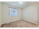 Simple bedroom with neutral walls, carpet, and a window with blinds at 303 Tumbleweed Dr, Brighton, CO 80601