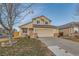 Charming two-story home with attached garage and landscaped yard at 303 Tumbleweed Dr, Brighton, CO 80601