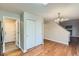 Bright hallway with hardwood floors and access to kitchen and other rooms at 303 Tumbleweed Dr, Brighton, CO 80601