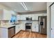 Modern kitchen with white cabinets, stainless steel appliances, and subway tile backsplash at 303 Tumbleweed Dr, Brighton, CO 80601