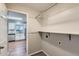 Laundry room with shelving, a washer/dryer hookup, and kitchen view at 303 Tumbleweed Dr, Brighton, CO 80601